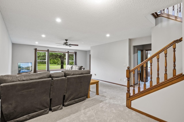 2801 263rd Ave NE, Isanti, MN 55040 - living room with light colored carpet, ceiling fan, recessed lighting, stairs, and a textured ceiling