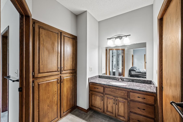 2801 263rd Ave NE, Isanti, MN 55040 - bathroom featuring vanity, a textured ceiling, and tile patterned floors