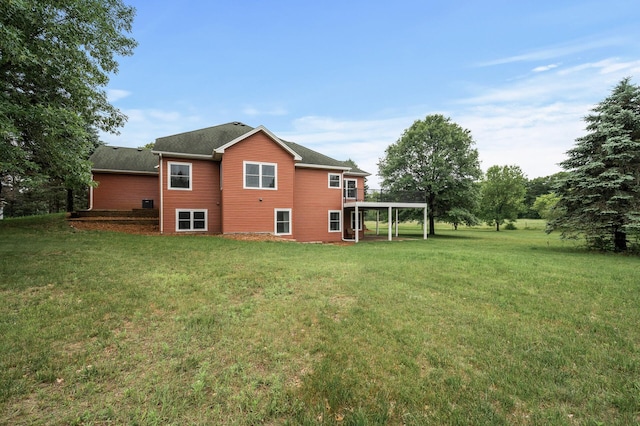 2801 263rd Ave NE, Isanti, MN 55040 - back of property featuring a yard, a deck, and a carport