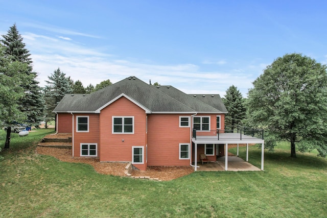 2801 263rd Ave NE, Isanti, MN 55040 - rear view of house featuring a patio, a lawn, a wooden deck, and a shingled roof