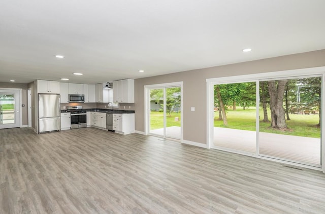 26877 Rainbow Ln, Merrifield, MN 56465 - unfurnished living room featuring plenty of natural light, light wood-style floors, and recessed lighting