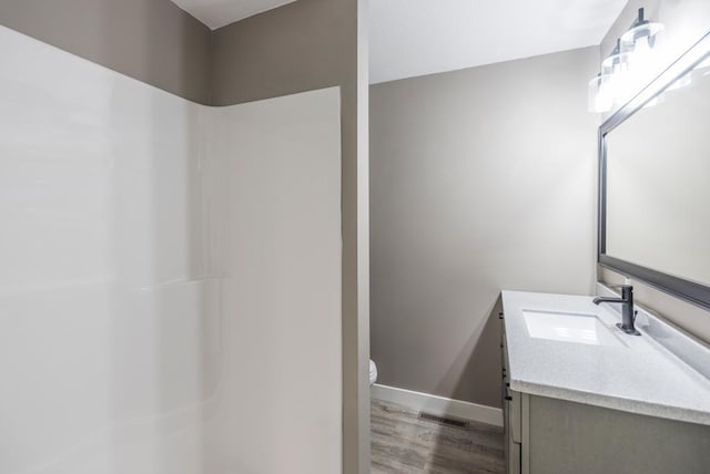 26877 Rainbow Ln, Merrifield, MN 56465 - full bath featuring wood finished floors, vanity, and a shower