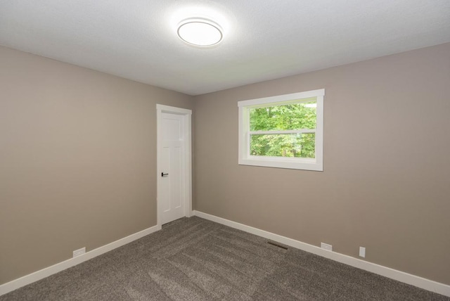 26877 Rainbow Ln, Merrifield, MN 56465 - unfurnished room with baseboards and dark colored carpet