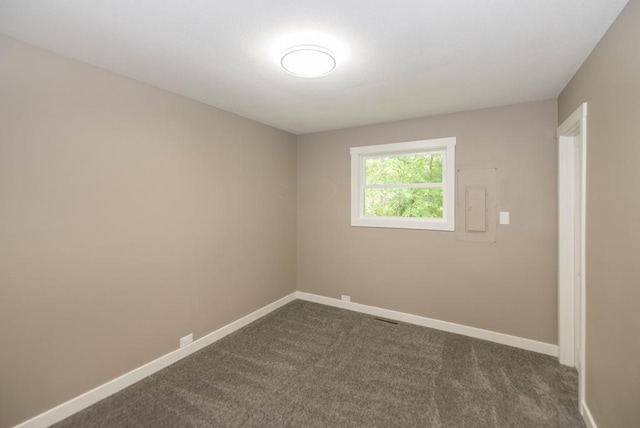 26877 Rainbow Ln, Merrifield, MN 56465 - unfurnished room featuring dark colored carpet and electric panel