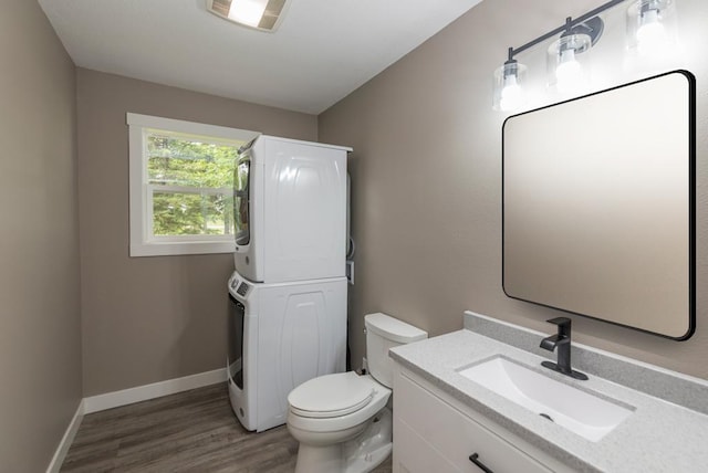 26877 Rainbow Ln, Merrifield, MN 56465 - half bath featuring estacked washer and dryer, vanity, and wood finished floors