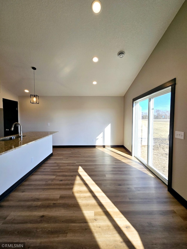 2003 Essler Dr, Saint Peter, MN 56082 - unfurnished living room with recessed lighting, vaulted ceiling, and dark wood finished floors