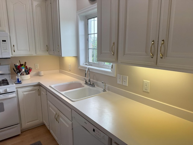 11030 Mississippi Blvd NW Unit 327, Coon Rapids, MN 55433 - kitchen featuring white appliances, white cabinets, light countertops, and light wood-style floors