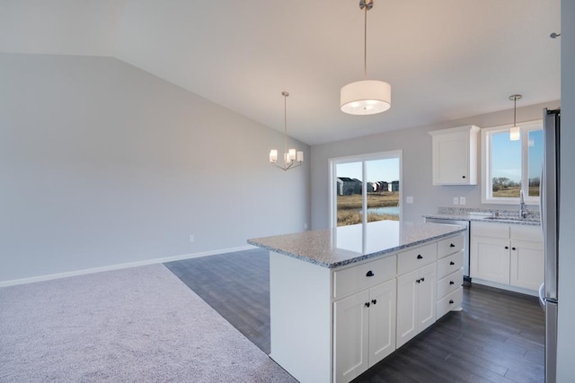 19916 English Ln N, Forest Lake, MN 55025 - kitchen featuring appliances with stainless steel finishes, light stone countertops, white cabinets, pendant lighting, and lofted ceiling