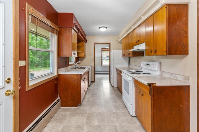 7 Pleasant Ave SE, Remer, MN 56672 - kitchen with white appliances, under cabinet range hood, a baseboard radiator, light countertops, and healthy amount of natural light