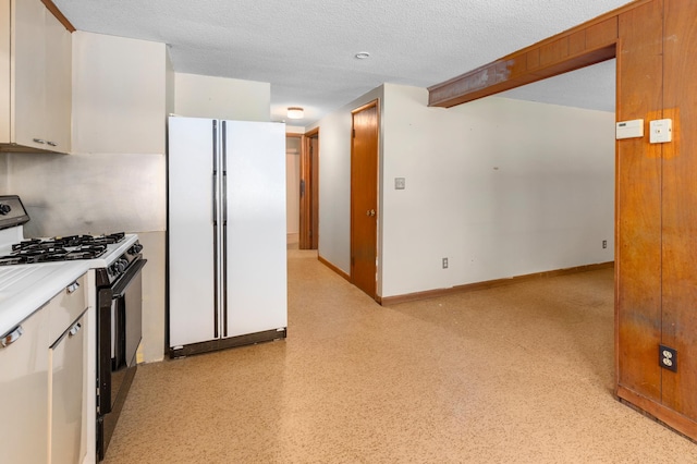 7 Pleasant Ave SE, Remer, MN 56672 - kitchen with freestanding refrigerator, black gas stove, light countertops, white cabinetry, and a textured ceiling