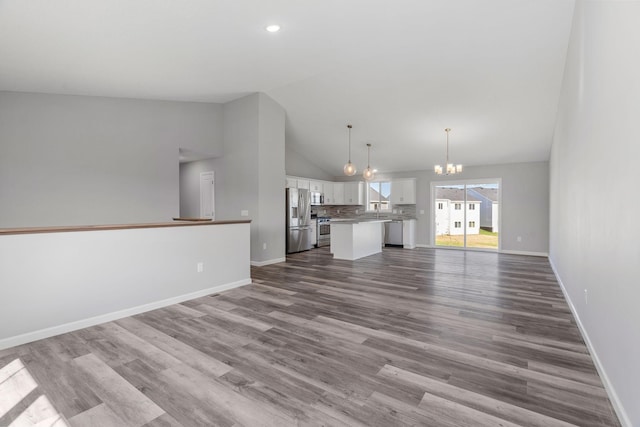 19926 English Ln N, Forest Lake, MN 55025 - unfurnished living room with a chandelier, dark wood finished floors, high vaulted ceiling, and recessed lighting