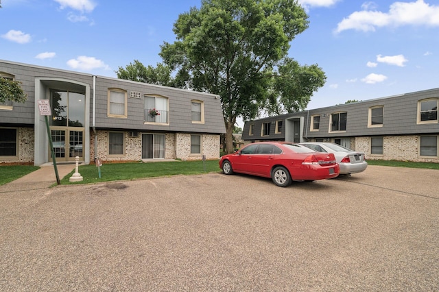 814 9th Ave S Unit 5, Hopkins, MN 55343 - townhome / multi-family property featuring brick siding, mansard roof, and uncovered parking