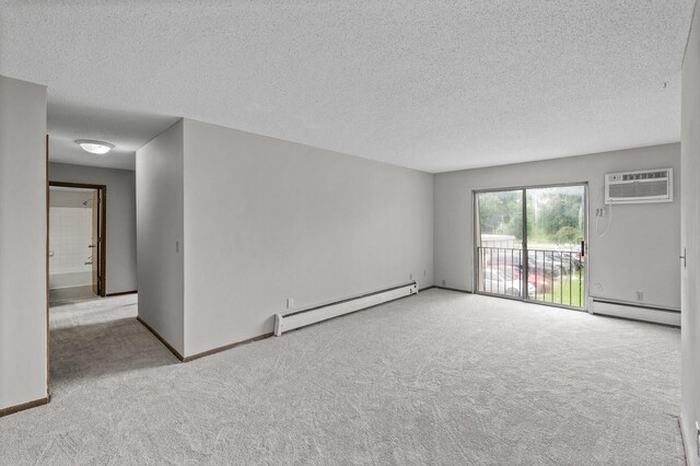 814 9th Ave S Unit 5, Hopkins, MN 55343 - carpeted spare room with baseboard heating, a wall mounted AC, and a textured ceiling