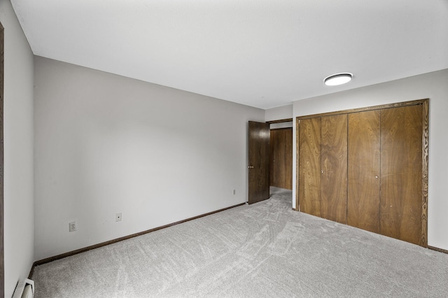 814 9th Ave S Unit 5, Hopkins, MN 55343 - unfurnished bedroom with light colored carpet, a baseboard heating unit, and a closet