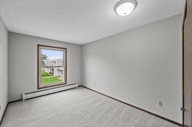 814 9th Ave S Unit 5, Hopkins, MN 55343 - spare room featuring a baseboard heating unit, carpet floors, and a textured ceiling