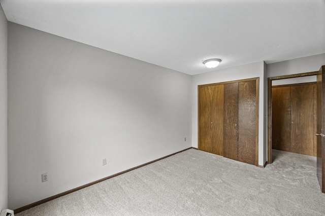 814 9th Ave S Unit 5, Hopkins, MN 55343 - unfurnished bedroom with carpet flooring, a closet, and baseboard heating