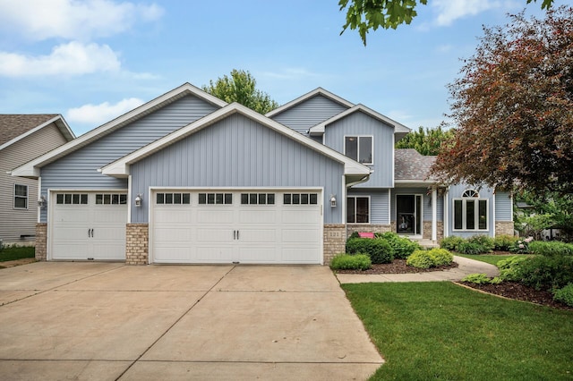121 Arbor St, Northfield, MN 55057 - view of front facade with a garage, driveway, stone siding, board and batten siding, and a front yard