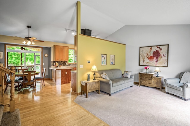 121 Arbor St, Northfield, MN 55057 - living room with vaulted ceiling, a ceiling fan, light wood finished floors, and rail lighting