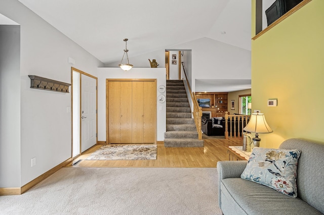 121 Arbor St, Northfield, MN 55057 - carpeted foyer featuring wood finished floors, stairway, and high vaulted ceiling