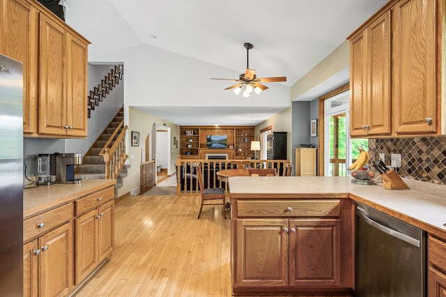 121 Arbor St, Northfield, MN 55057 - kitchen featuring appliances with stainless steel finishes, lofted ceiling, a peninsula, light countertops, and light wood finished floors