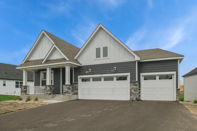 9734 49th St NE, Saint Michael, MN 55376 - craftsman inspired home with board and batten siding, asphalt driveway, a porch, stone siding, and a shingled roof