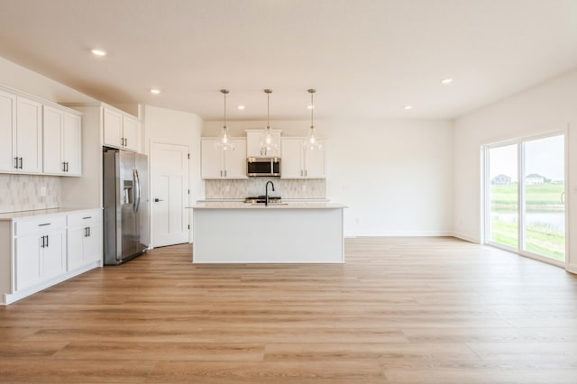 9734 49th St NE, Saint Michael, MN 55376 - kitchen with appliances with stainless steel finishes, recessed lighting, decorative backsplash, white cabinets, and light countertops