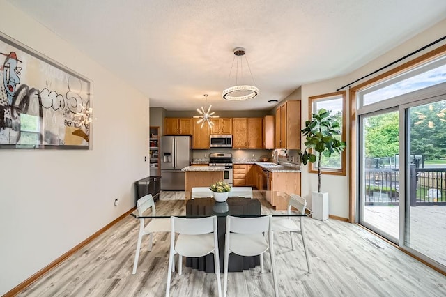 6788 Carlisle Curv, Shakopee, MN 55379 - dining space with a chandelier and light wood-type flooring