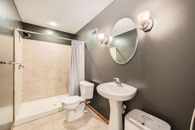 6788 Carlisle Curv, Shakopee, MN 55379 - bathroom with tile patterned floors, a textured ceiling, and a stall shower