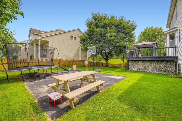 6788 Carlisle Curv, Shakopee, MN 55379 - fenced backyard with a trampoline, a gazebo, and a patio