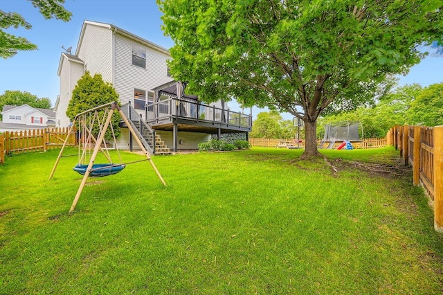 6788 Carlisle Curv, Shakopee, MN 55379 - fenced backyard with a trampoline, a deck, and stairway