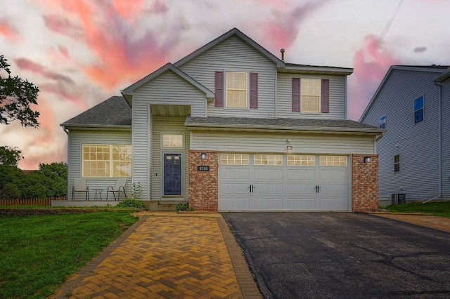 6788 Carlisle Curv, Shakopee, MN 55379 - traditional-style house with driveway, an attached garage, a yard, and brick siding