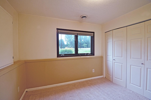 16535 58th St NE, Otsego, MN 55330 - unfurnished bedroom featuring carpet floors, a textured ceiling, and a closet