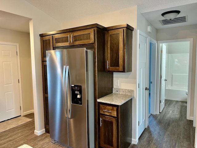 720 Cherrywood Ln NE, Isanti, MN 55040 - kitchen with stainless steel fridge, dark wood-style flooring, light stone countertops, and dark brown cabinets