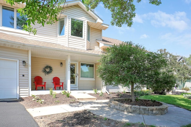 10902 Eagle Lake Blvd, Maple Grove, MN 55369 - view of front of house featuring covered porch and a shingled roof