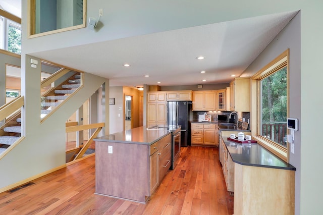 10902 Eagle Lake Blvd, Maple Grove, MN 55369 - kitchen with freestanding refrigerator, a center island, light wood finished floors, plenty of natural light, and recessed lighting