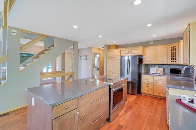 10902 Eagle Lake Blvd, Maple Grove, MN 55369 - kitchen featuring stainless steel appliances, light wood-style flooring, light brown cabinetry, a center island, and recessed lighting
