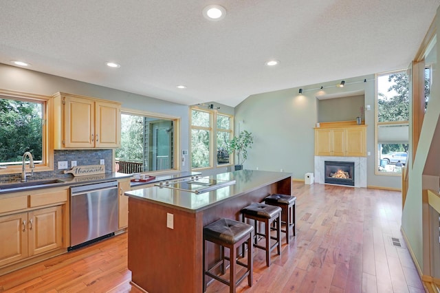 10902 Eagle Lake Blvd, Maple Grove, MN 55369 - kitchen with dishwasher, black electric stovetop, light brown cabinets, a breakfast bar area, and light wood-type flooring