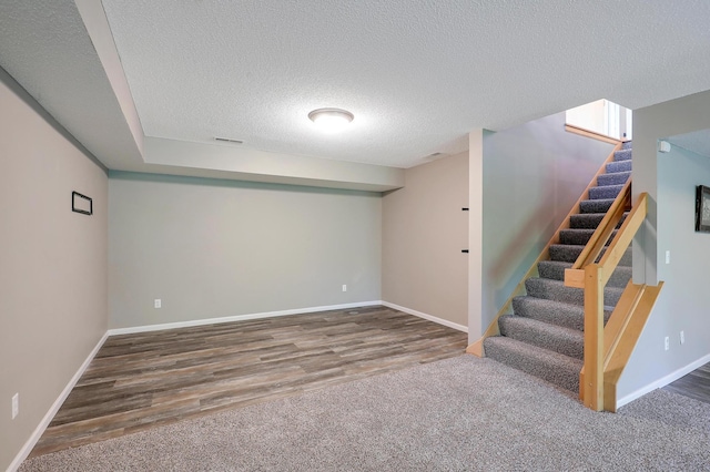 10902 Eagle Lake Blvd, Maple Grove, MN 55369 - finished basement with stairs, a textured ceiling, and wood finished floors