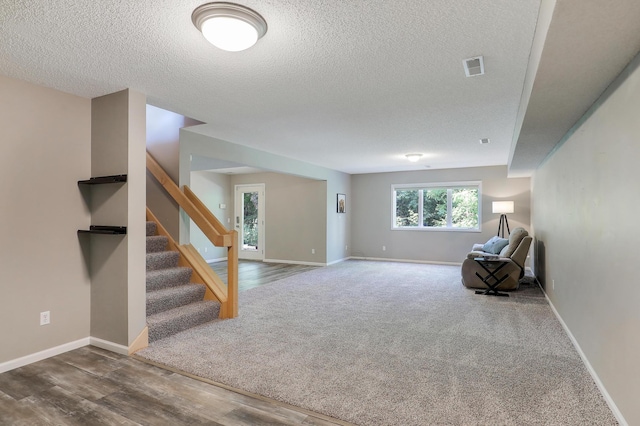 10902 Eagle Lake Blvd, Maple Grove, MN 55369 - unfurnished room featuring a textured ceiling, stairway, carpet, and wood finished floors