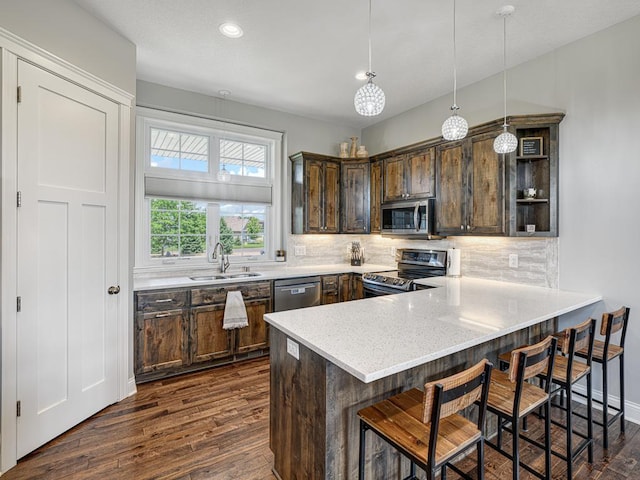 6937 94th St S, Cottage Grove, MN 55016 - kitchen featuring appliances with stainless steel finishes, dark wood-type flooring, dark brown cabinets, decorative backsplash, and recessed lighting