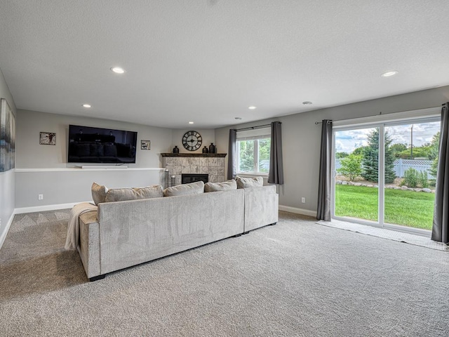 6937 94th St S, Cottage Grove, MN 55016 - carpeted living area with a fireplace, recessed lighting, and a textured ceiling