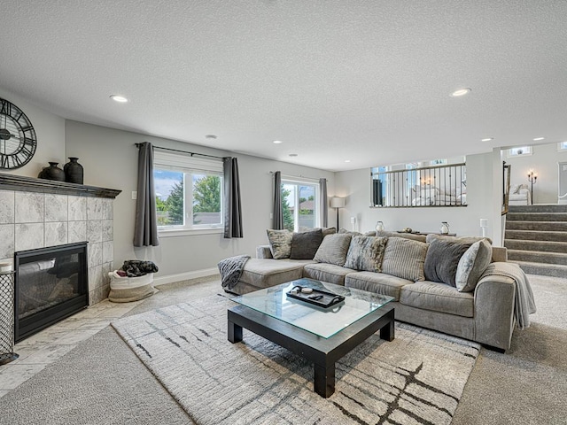 6937 94th St S, Cottage Grove, MN 55016 - living area with recessed lighting, a textured ceiling, stairs, and a tile fireplace