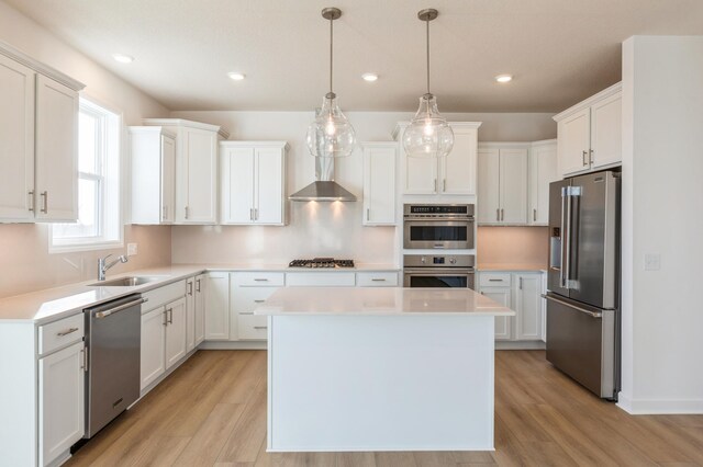 7200 Auburn Ln, Inver Grove Heights, MN 55077 - kitchen with appliances with stainless steel finishes, a center island, white cabinets, light wood-style flooring, and recessed lighting