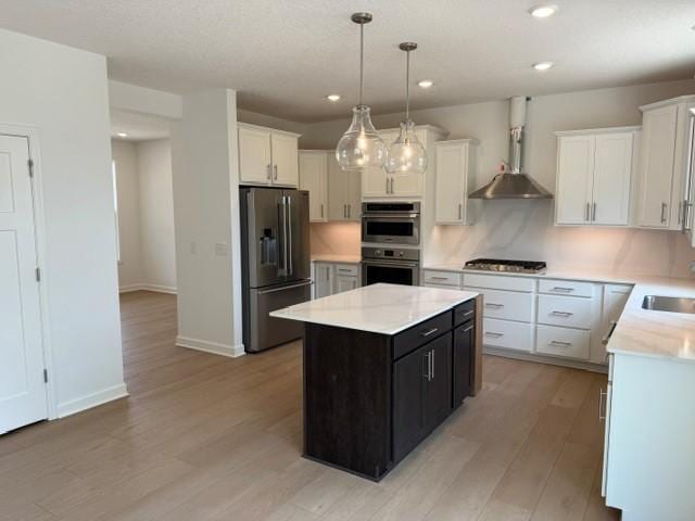 7200 Auburn Ln, Inver Grove Heights, MN 55077 - kitchen with appliances with stainless steel finishes, a kitchen island, light countertops, light wood finished floors, and white cabinets