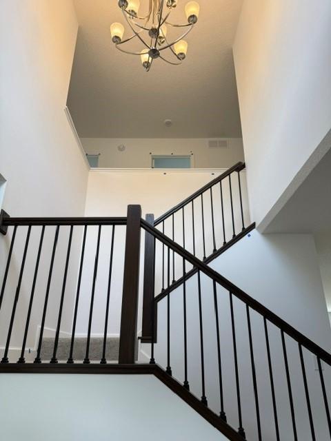 7200 Auburn Ln, Inver Grove Heights, MN 55077 - stairway with a chandelier