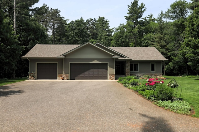 21601 Timber Hills Trl, Nisswa, MN 56468 - view of front facade featuring a garage, stone siding, driveway, a front yard, and a shingled roof