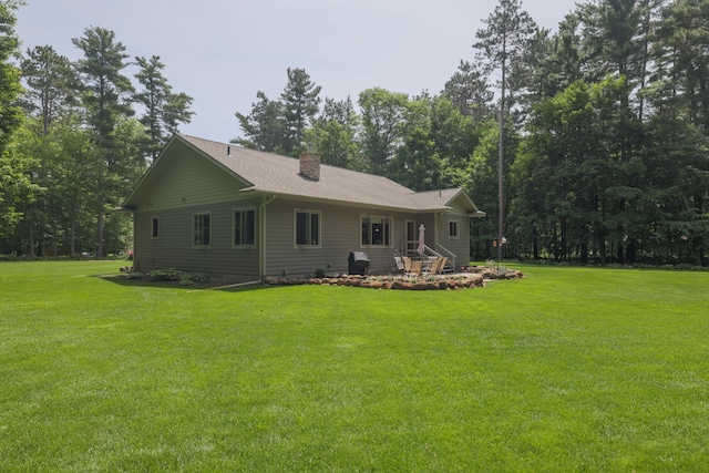 21601 Timber Hills Trl, Nisswa, MN 56468 - back of house with a chimney and a lawn