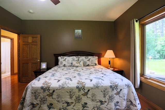 21601 Timber Hills Trl, Nisswa, MN 56468 - bedroom featuring wood finished floors, multiple windows, and ceiling fan