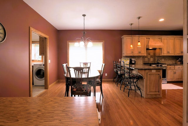 21601 Timber Hills Trl, Nisswa, MN 56468 - dining room featuring washer / dryer, a chandelier, light wood-style flooring, and recessed lighting