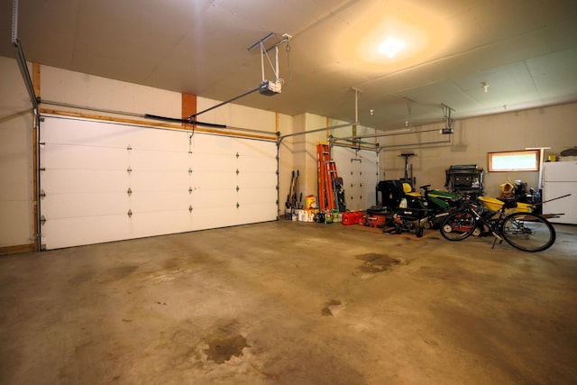 21601 Timber Hills Trl, Nisswa, MN 56468 - garage with a garage door opener and freestanding refrigerator